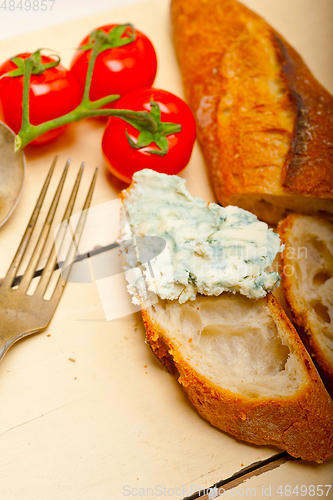 Image of fresh blue cheese spread ove french baguette