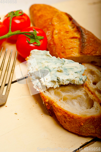 Image of fresh blue cheese spread ove french baguette