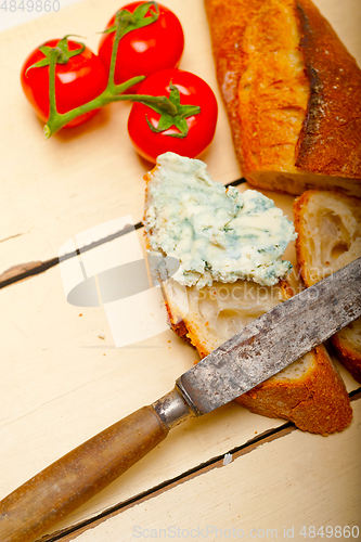 Image of fresh blue cheese spread ove french baguette