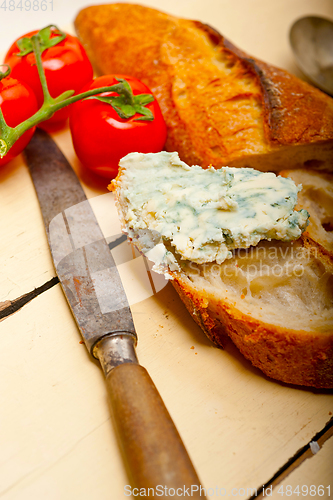 Image of fresh blue cheese spread ove french baguette