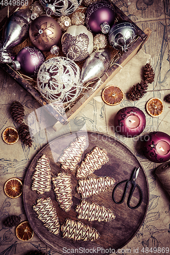 Image of Christmas cookies in tree shape with ornaments in vintage style