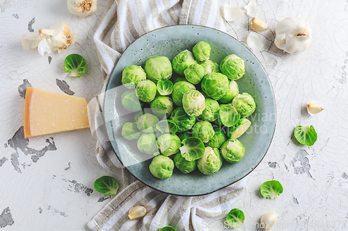 Image of Raw Brussel sprouts with salt and Parmesan cheese in bowl