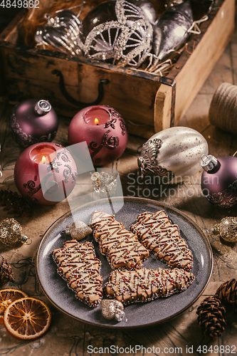 Image of Christmas cookies in tree shape with ornaments in vintage style