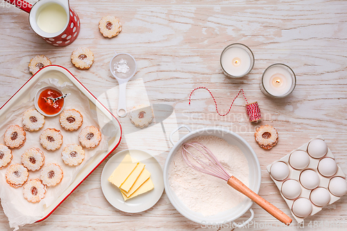 Image of Homemade Christmas cookies with baking ingredients in white