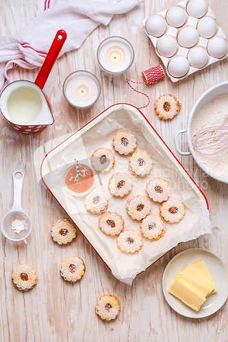 Image of Homemade Christmas cookies with baking ingredients in white