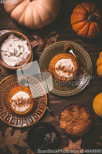 Image of Homemade small pumpkin pies with icing for Thanksgiving