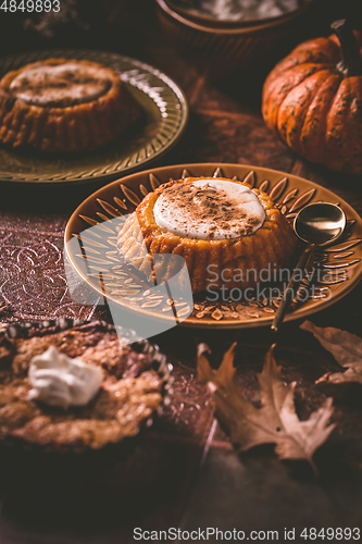 Image of Homemade small pumpkin pies with icing for Thanksgiving