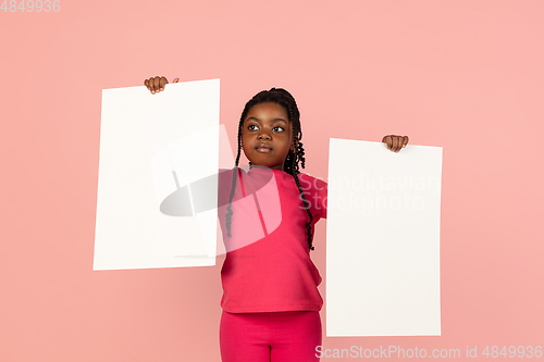 Image of Handsome african little girl portrait isolated on pink studio background with copyspace