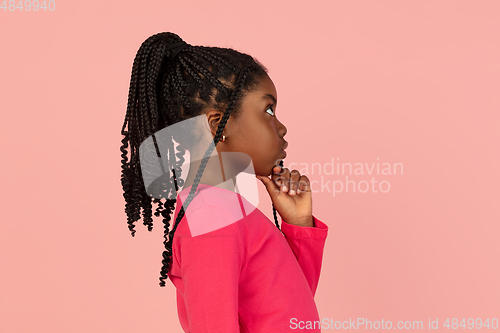 Image of Handsome african little girl portrait isolated on pink studio background with copyspace