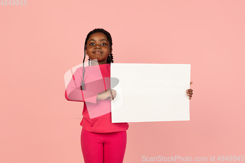 Image of Handsome african little girl portrait isolated on pink studio background with copyspace