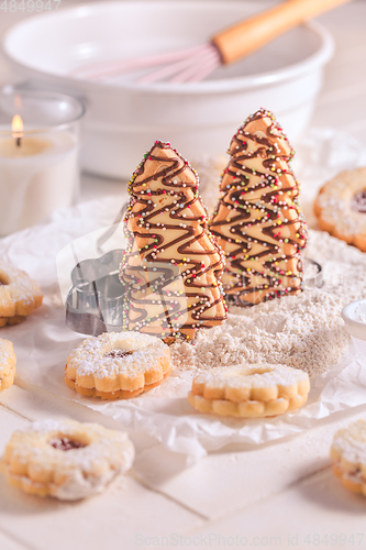 Image of Christmas gingerbread and cookies with baking ingredients in whi