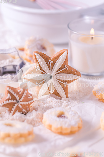 Image of Christmas gingerbread and cookies with baking ingredients in white