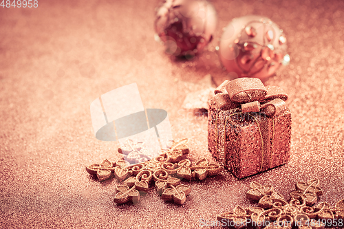 Image of Christmas glitter background with ornaments and present box 