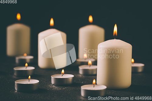 Image of Candle flames glowing in the dark, spiritual atmosphere, religion and Christmas