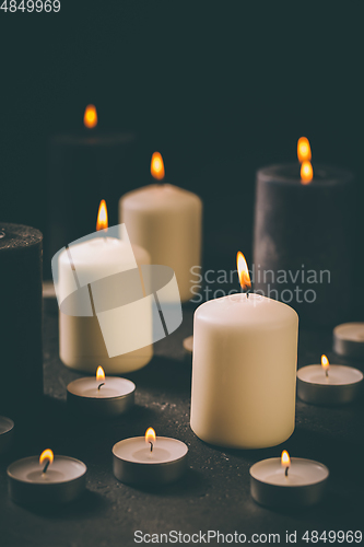 Image of Candle flames glowing in the dark, spiritual atmosphere, religion and Christmas