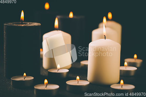 Image of Candle flames glowing in the dark, spiritual atmosphere, religion and Christmas