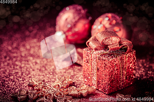 Image of Christmas glitter ornaments and present box 