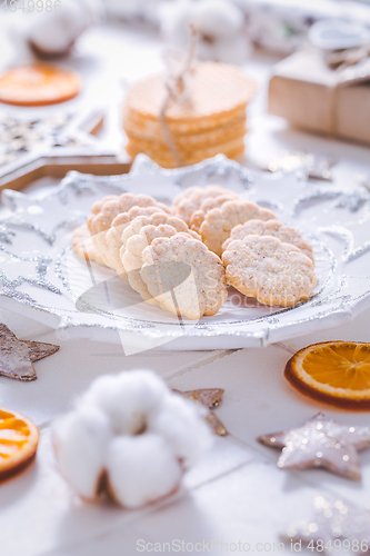 Image of Christmas cookies with orange slices, ornaments on white background