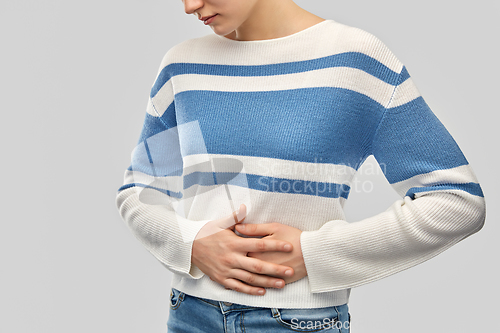 Image of teenage girl having stomach ache