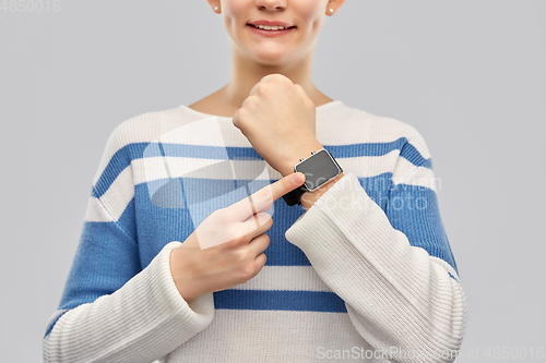 Image of happy smiling teenage girl with smart watch