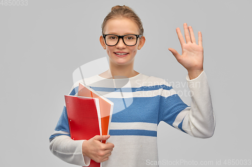 Image of happy smiling teenage student girl with notebooks