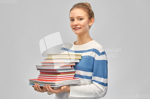 Image of happy smiling teenage student girl with books