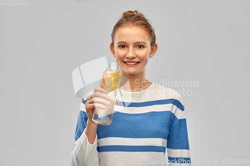 Image of teenage girl with glass bottle of fruit water