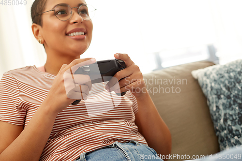 Image of african american woman with gamepad playing game