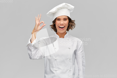 Image of happy smiling female chef showing ok hand sign