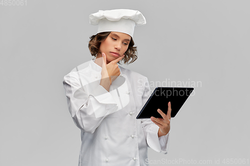 Image of female chef in toque with tablet computer