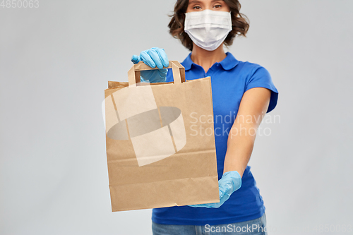 Image of delivery woman in face mask with paper bag