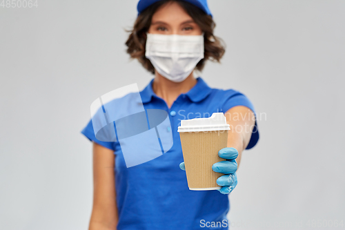 Image of saleswoman in face mask with takeaway coffee cup