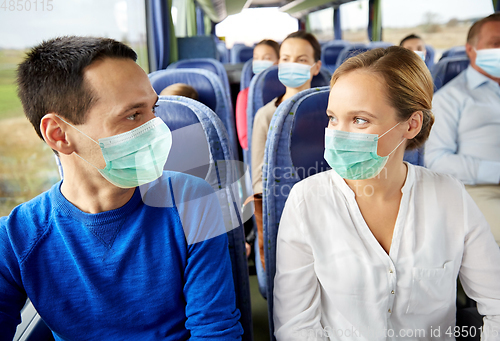 Image of couple of passengers in medical mask in travel bus