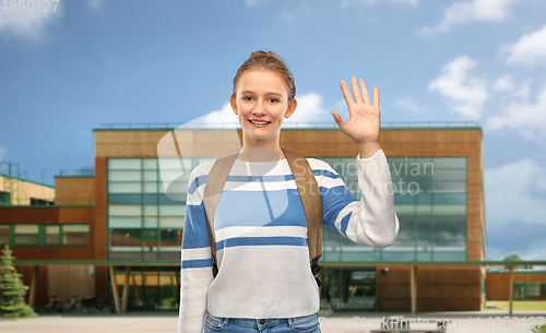 Image of smiling teenage student girl with school bag