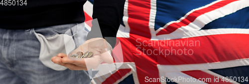 Image of close up of man showing coins and empty pockets