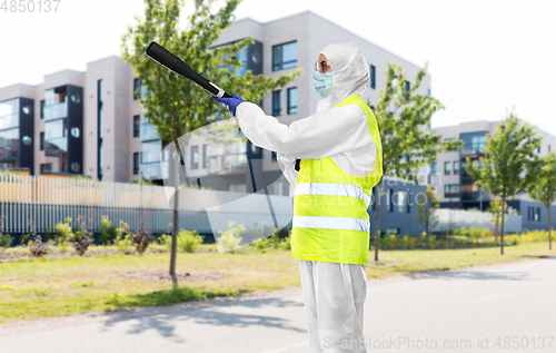 Image of sanitation worker in hazmat with pressure washer