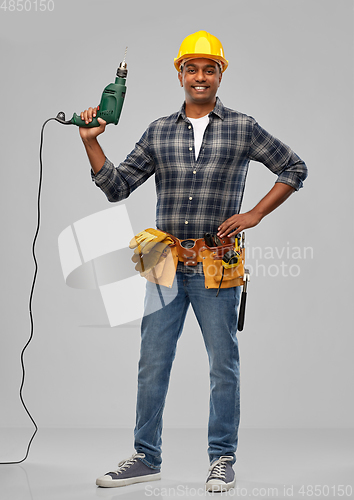 Image of happy indian builder in helmet with electric drill