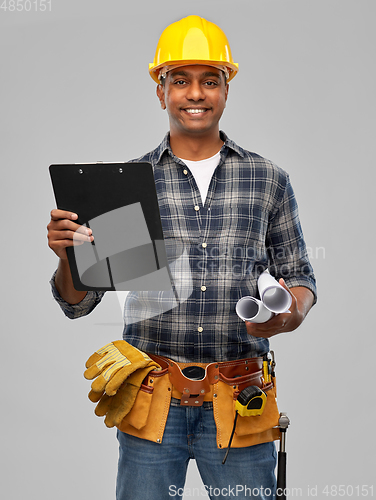 Image of happy indian builder with blueprint and clipboard