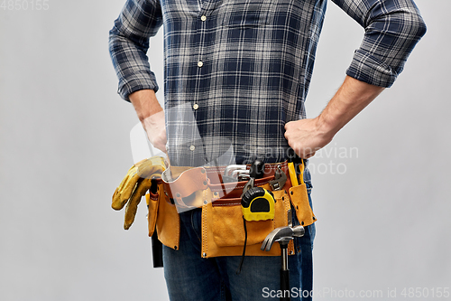 Image of male worker or builder with working tools on belt