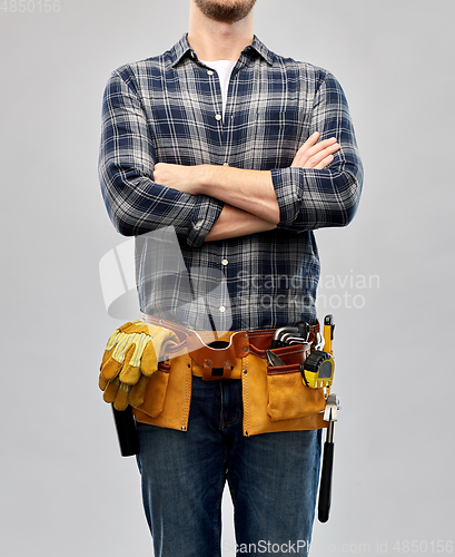 Image of male worker or builder with working tools on belt