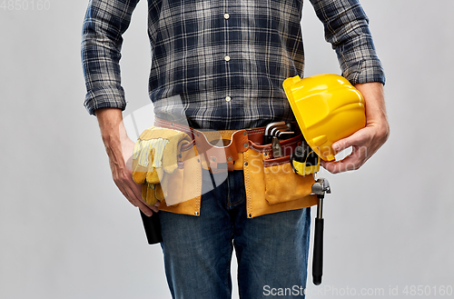 Image of worker or builder with helmet and working tools