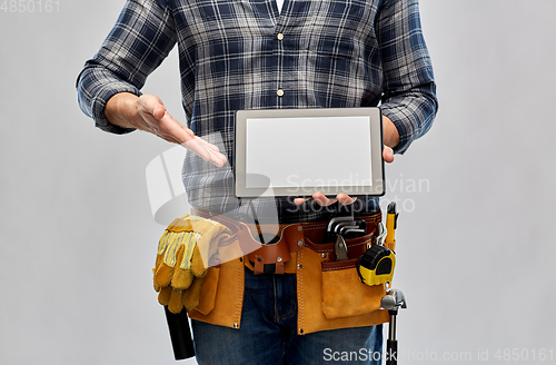 Image of male builder with working tools showing tablet pc