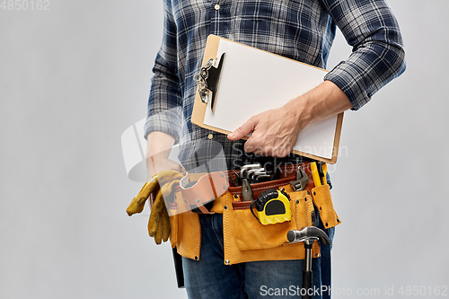 Image of male builder with clipboard and working tools