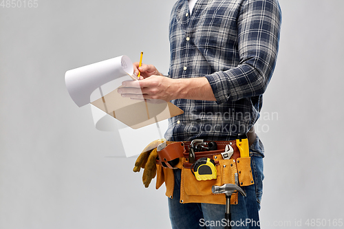 Image of builder with clipboard, pencil and working tools