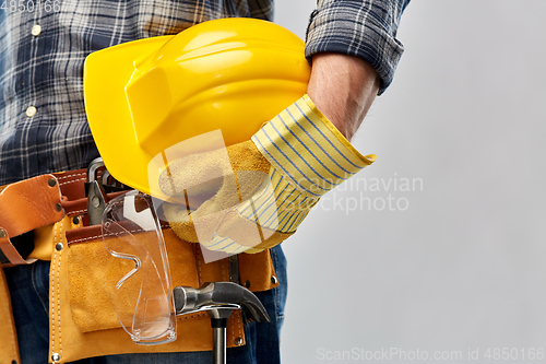 Image of worker or builder with helmet and working tools