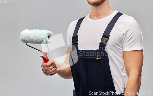 Image of close up of painter or builder with paint roller