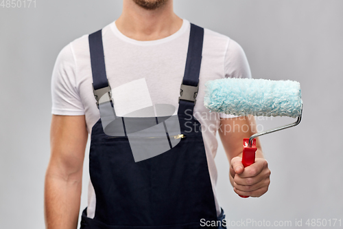 Image of close up of painter or builder with paint roller