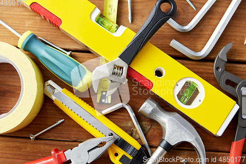 Image of different work tools on wooden boards background