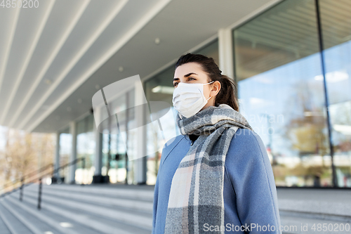 Image of woman wearing protective medical mask in city