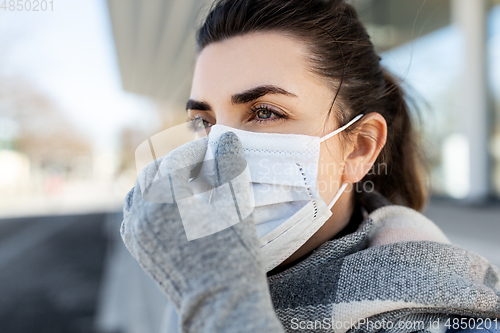 Image of woman wearing protective medical mask in city